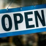 Enseigne « open » sur une porte vitrée, le site web comme porte d'entrée commerciale